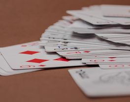 A fanned spread of playing cards on a table
