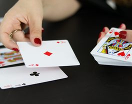 A player laying a card down during a card game